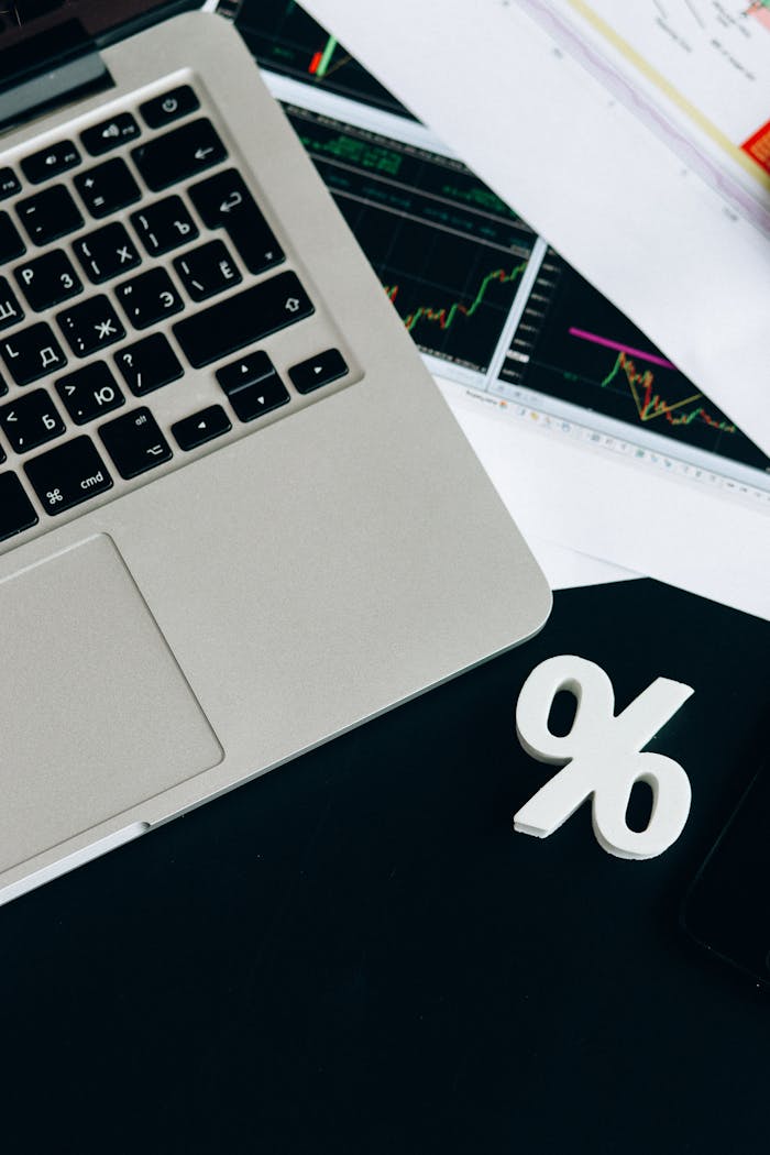Close-up of a laptop keyboard with percentage symbol, representing financial analysis and investment concepts.